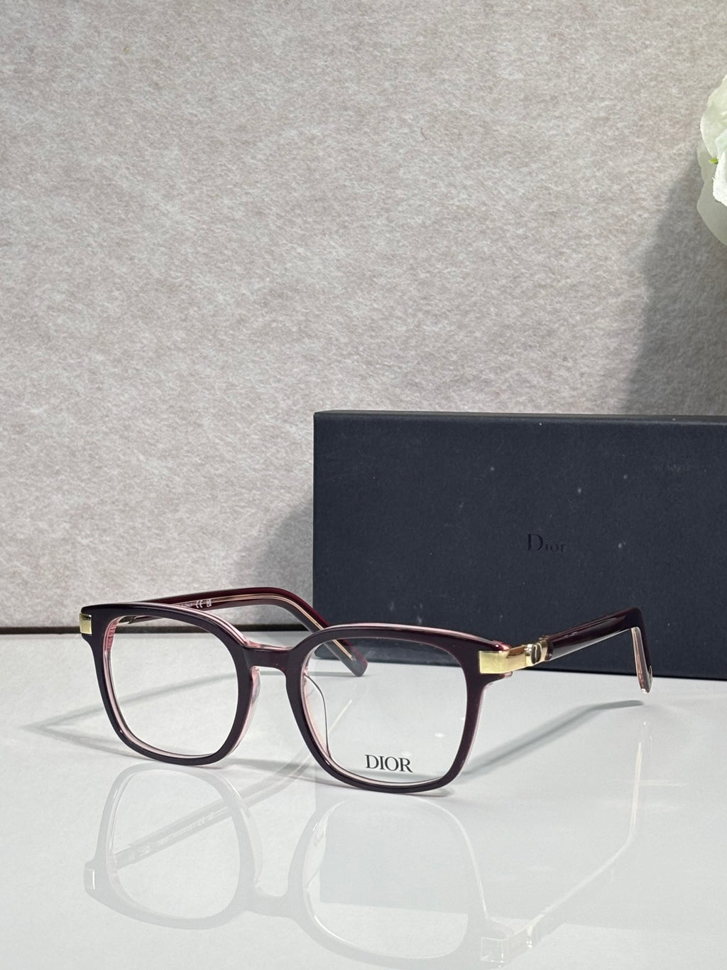 Dior eyeglasses with burgundy acetate frames and rectangular clear lenses