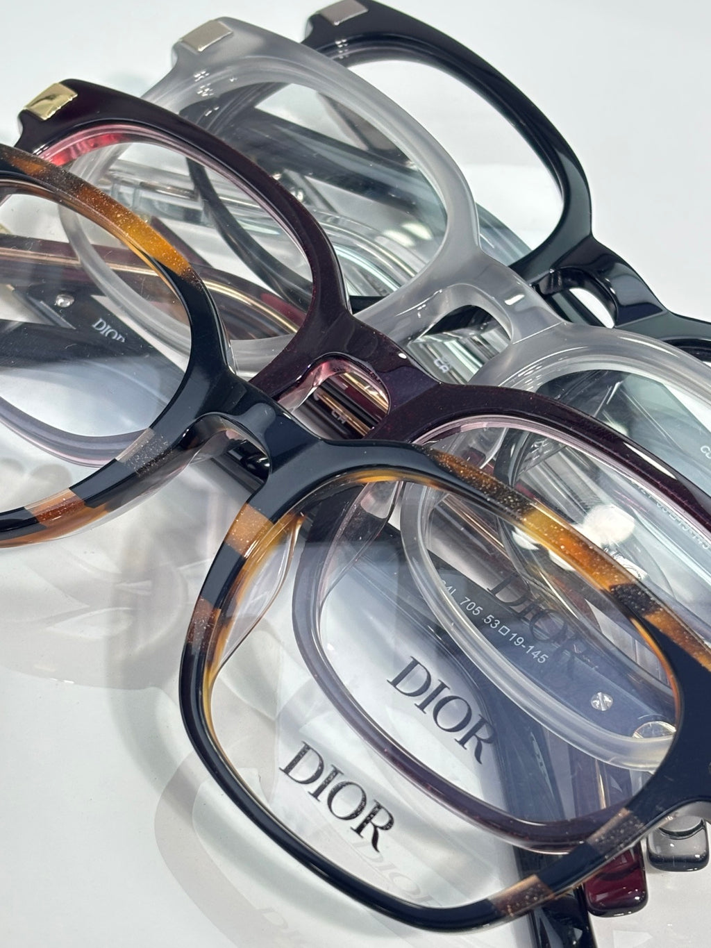 Assorted Dior eyeglasses with clear and tortoiseshell frames and clear lenses