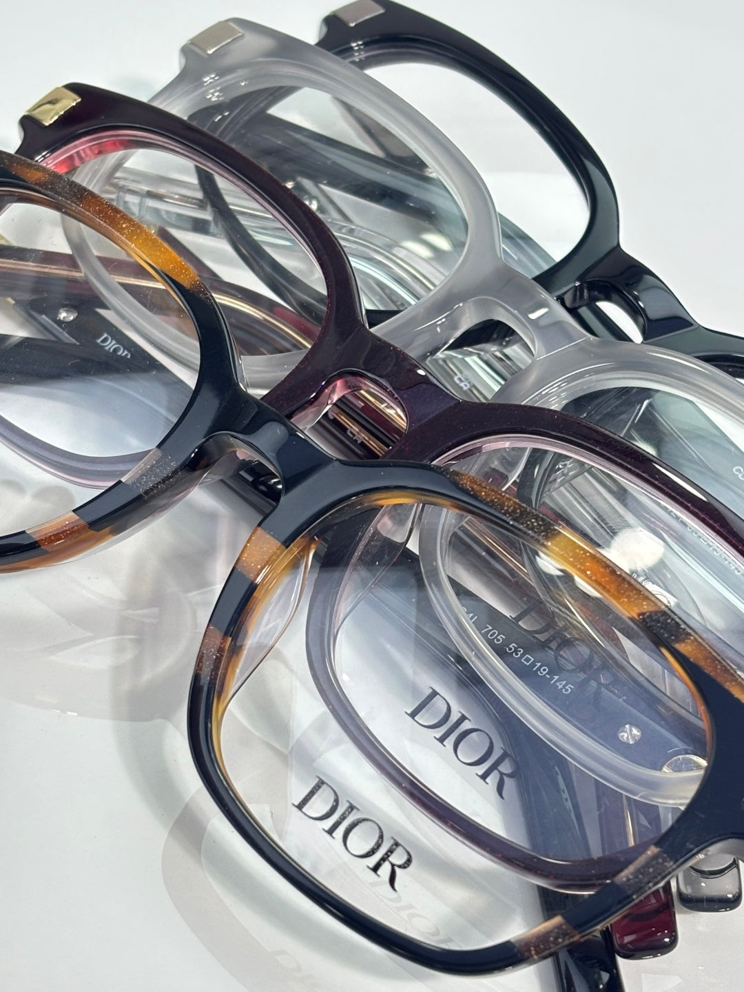 Assorted Dior eyeglasses with clear and tortoiseshell frames and clear lenses