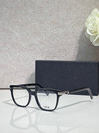 Dior optical glasses with dark navy/black rectangular frames and gold front accents.