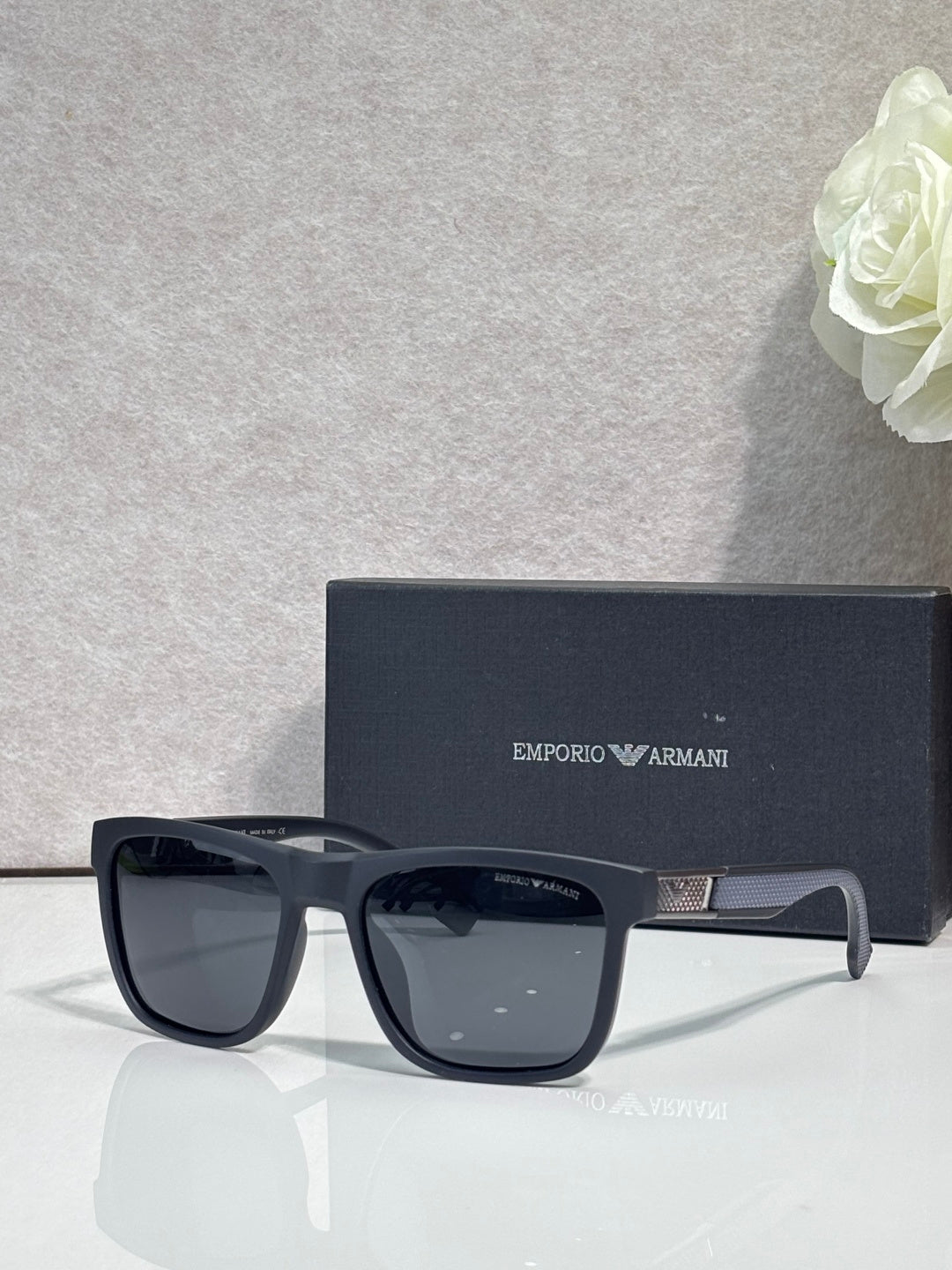 Designer glasses with dark frame and dark square lenses, glossy finish