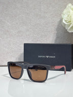 Designer glasses with gray frames, brown tinted lenses, and multicolor temple detail