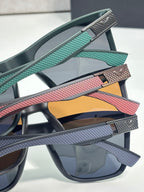 Eyeglasses temple close-up with teal, red, and gray textured bands and metal tips