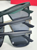 Prada sunglasses temple close-up with teal texture and engraved Prada logo on arms