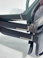 Prada sunglasses temple close-up with textured strap and engraved Prada lettering