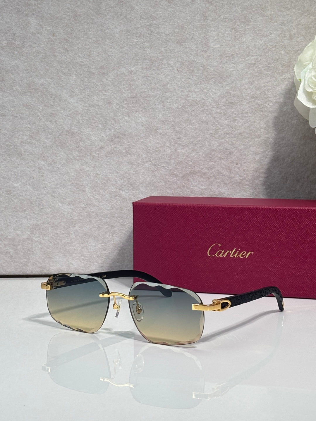 Cartier eyeglasses, black frame with gold temples, gold reflective lenses
