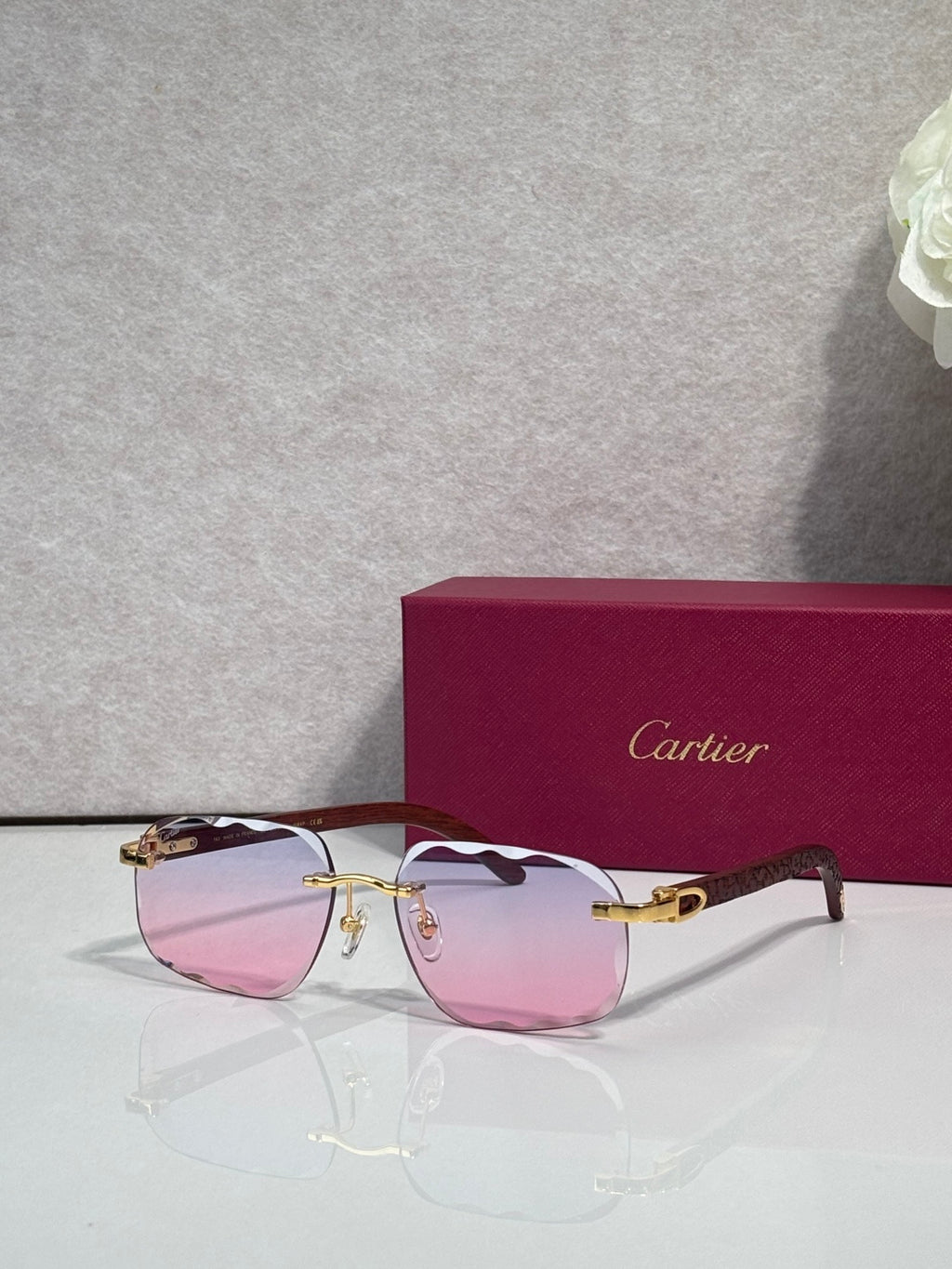 Cartier eyeglasses, black frame with gold temples, pink-tinted lenses