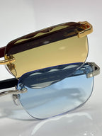 Cartier eyeglasses close-up, brown top rim, gold hardware, blue-tinted lenses