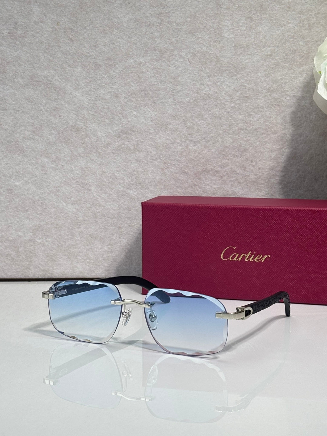 Blue-tinted frame eyeglasses with light blue lenses and gold-tone accents