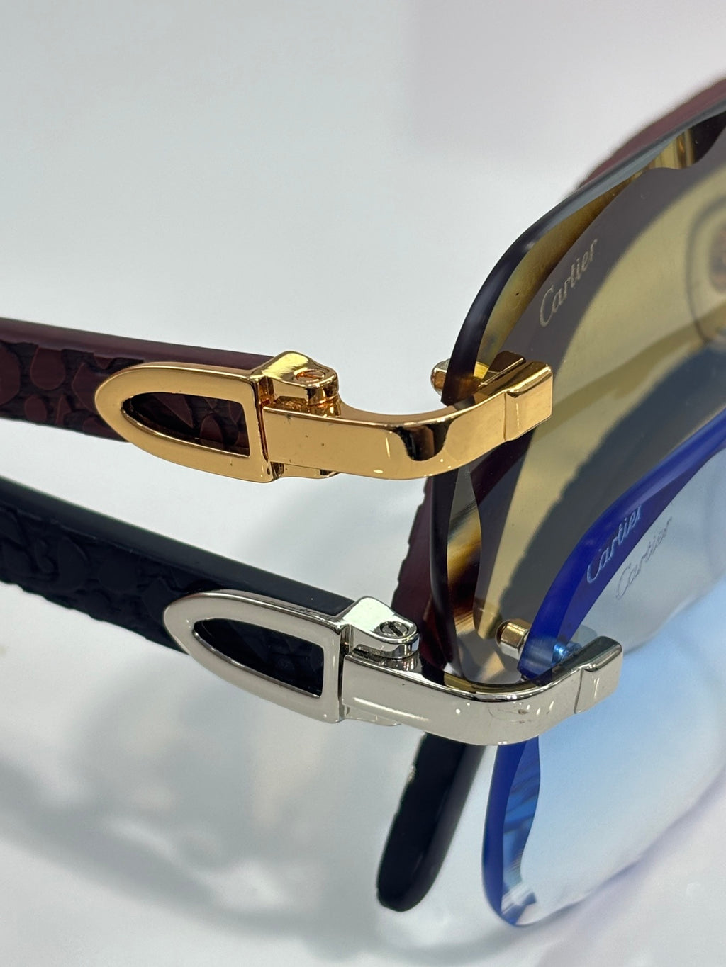 Gold and silver eyeglasses hinge with dark patterned temples and tinted lenses