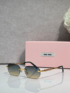 MiuMiu sunglasses with gold metal frame, dark lenses, and jeweled temple detail