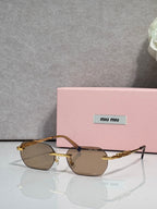 MiuMiu sunglasses with gold metal frame, dark lenses, and jeweled temple detail