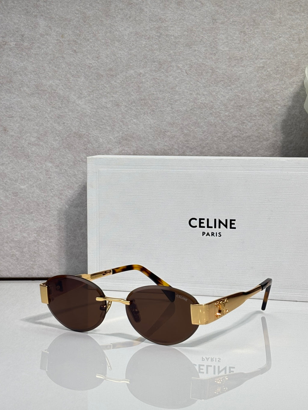 Tortoiseshell round sunglasses with gold-tone hinges and brown tinted lenses