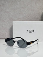 Black round sunglasses with gold-tone hinges and dark gray tinted lenses