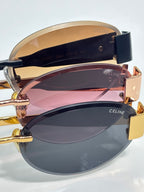 Celine glasses stacked close-up showing navy temples and colored lens interiors