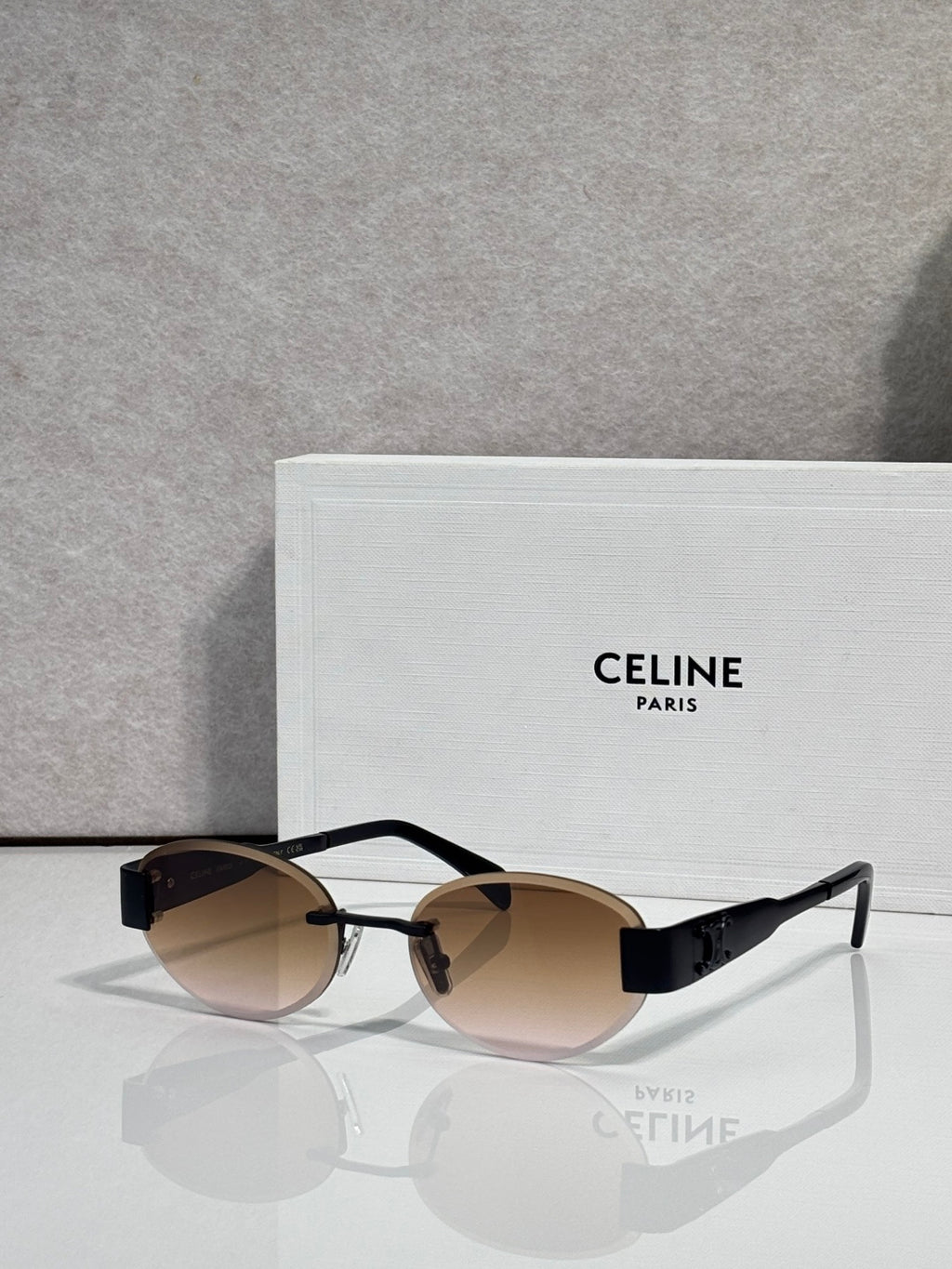 Celine glasses with black frames and brown-tinted lenses, metal temple arms