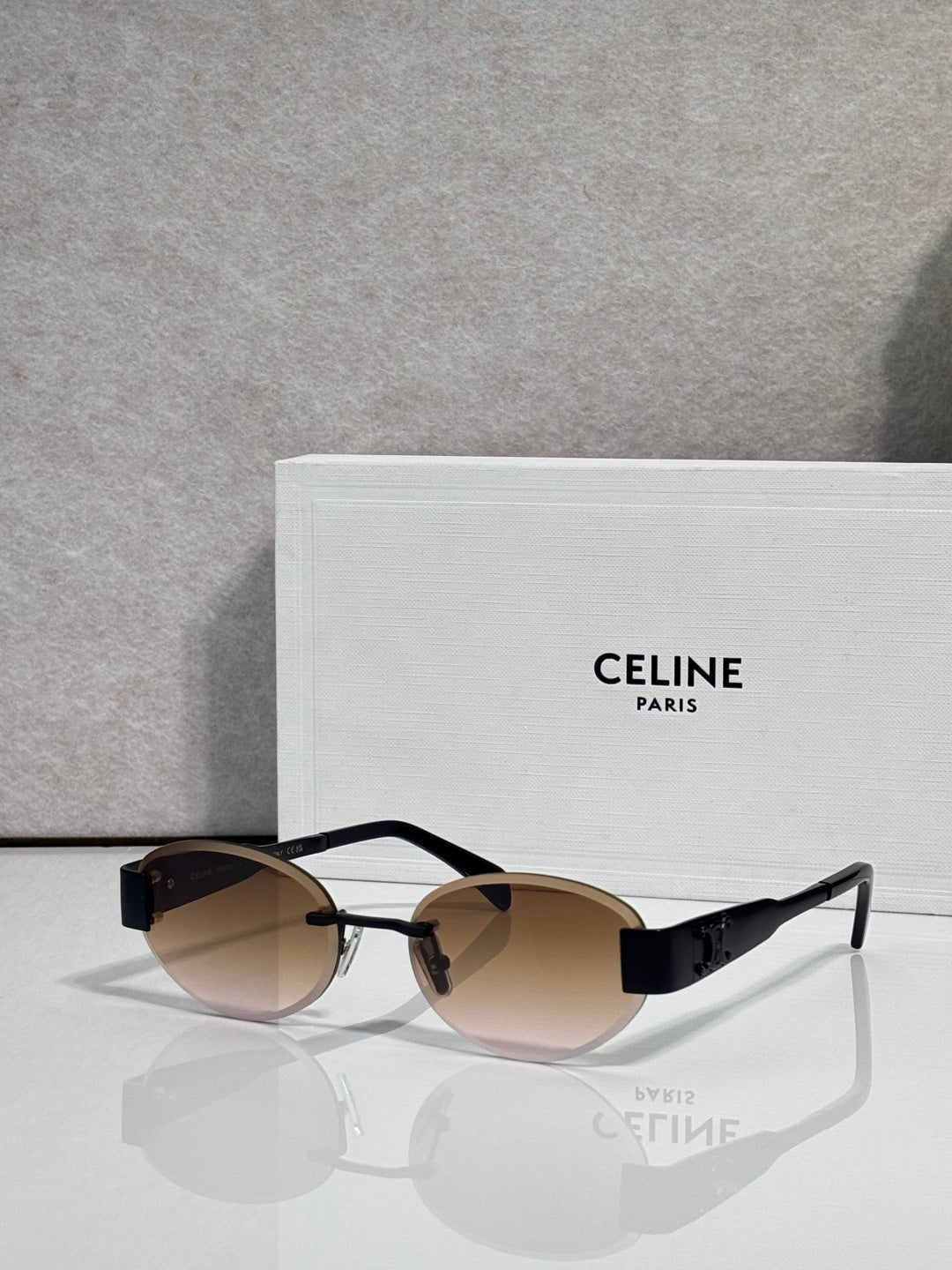 Celine glasses with black frames and brown-tinted lenses, metal temple arms