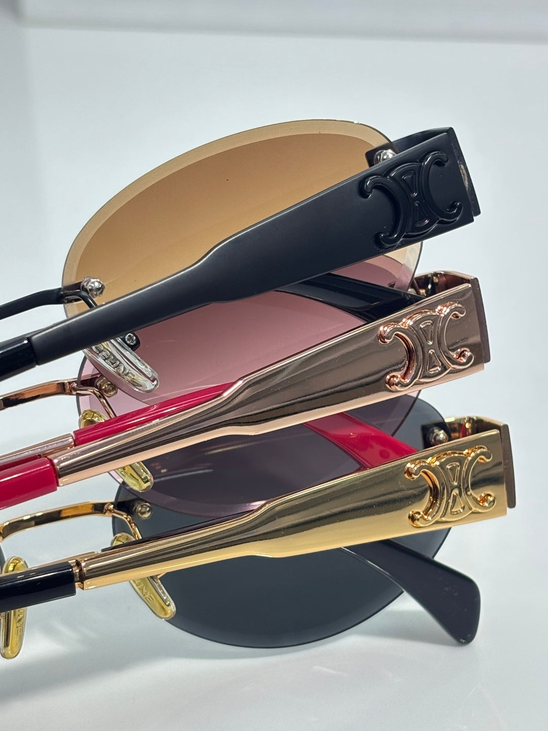 Celine glasses close-up of multiple frames with gold and navy temple details