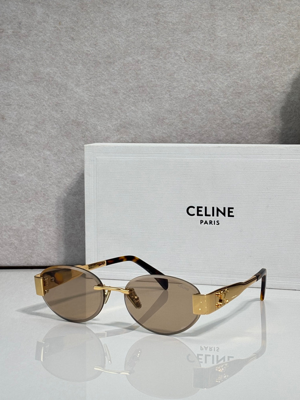Celine glasses with gold frame and brown-tinted round lenses, slim metal arms