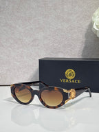 Versace glasses with tortoiseshell round frames, tinted lenses, gold medallion on temple