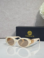 Versace glasses with white round frames, tinted lenses, gold medallion on temple