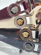 Versace glasses close-up: gold and silver temple details with Medusa medallions