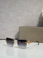 Gold-framed rectangular sunglasses with dark gradient lenses and butterfly bridge charm