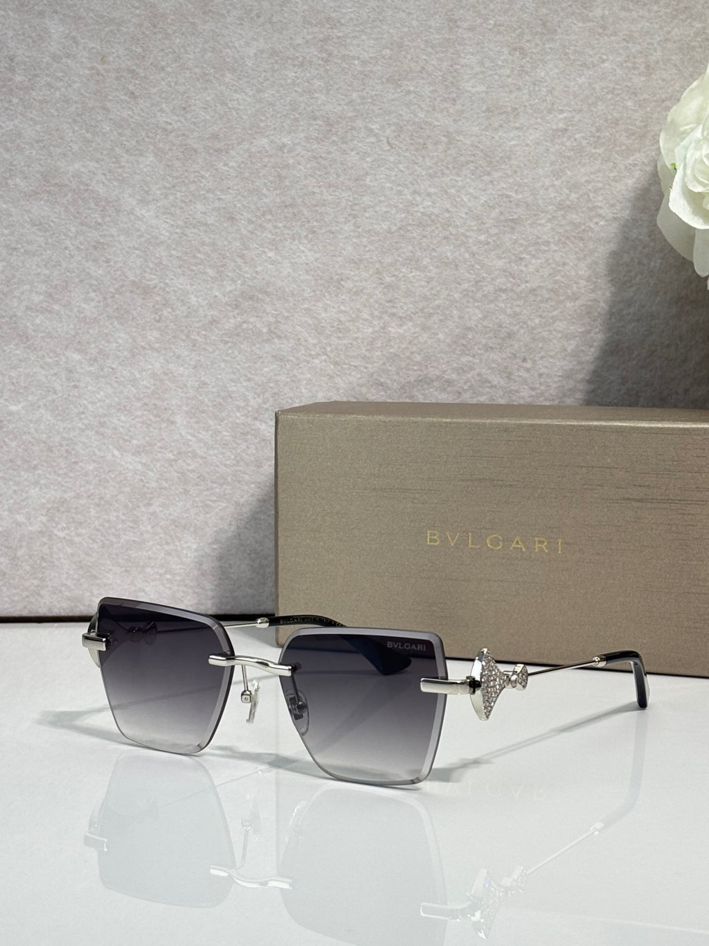 Gold-framed square sunglasses with dark gradient lenses and star-shaped bridge charm