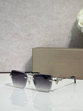 Gold-framed square sunglasses with dark gradient lenses and star-shaped bridge charm