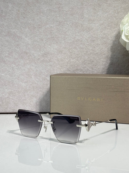 Gold-framed square sunglasses with dark gradient lenses and star-shaped bridge charm