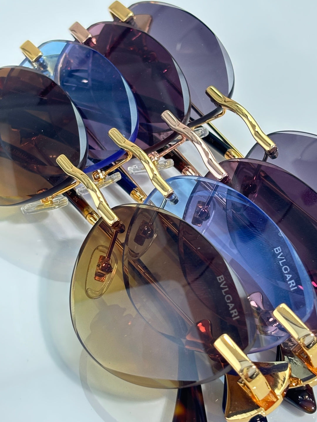 Sunglasses close-up with mirrored blue lenses and gold metal frame, BVLGARI