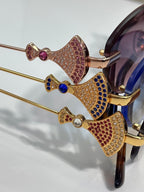 Jeweled sunglasses temple detail with multicolor rhinestones on gold frame
