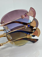 Jeweled sunglasses with layered purple and blue lenses, gold metal frame