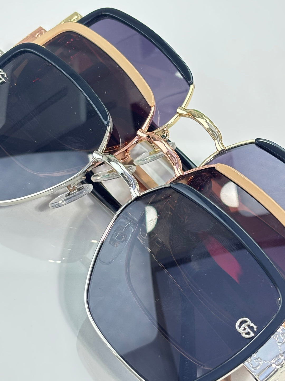 Gucci sunglasses close-up with gold-trim frames and dark blue tinted lenses