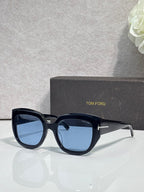 Square sunglasses with dark frames and blue-tinted lenses, TOM FORD temple branding