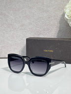 Angled square sunglasses with navy frames and dark gray lenses, TOM FORD temple branding