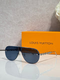 Sunglasses with dark gradient lenses and gold-tone chain detail, rectangular shape