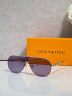 Sunglasses with purple-tinted lenses and gold-tone chain detail, thin metal frame