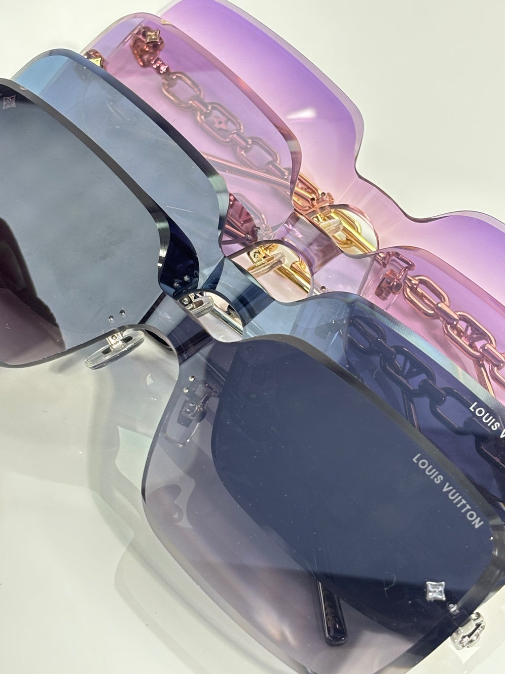 Louis Vuitton sunglasses, purple lenses, gold chain trim, dark frame