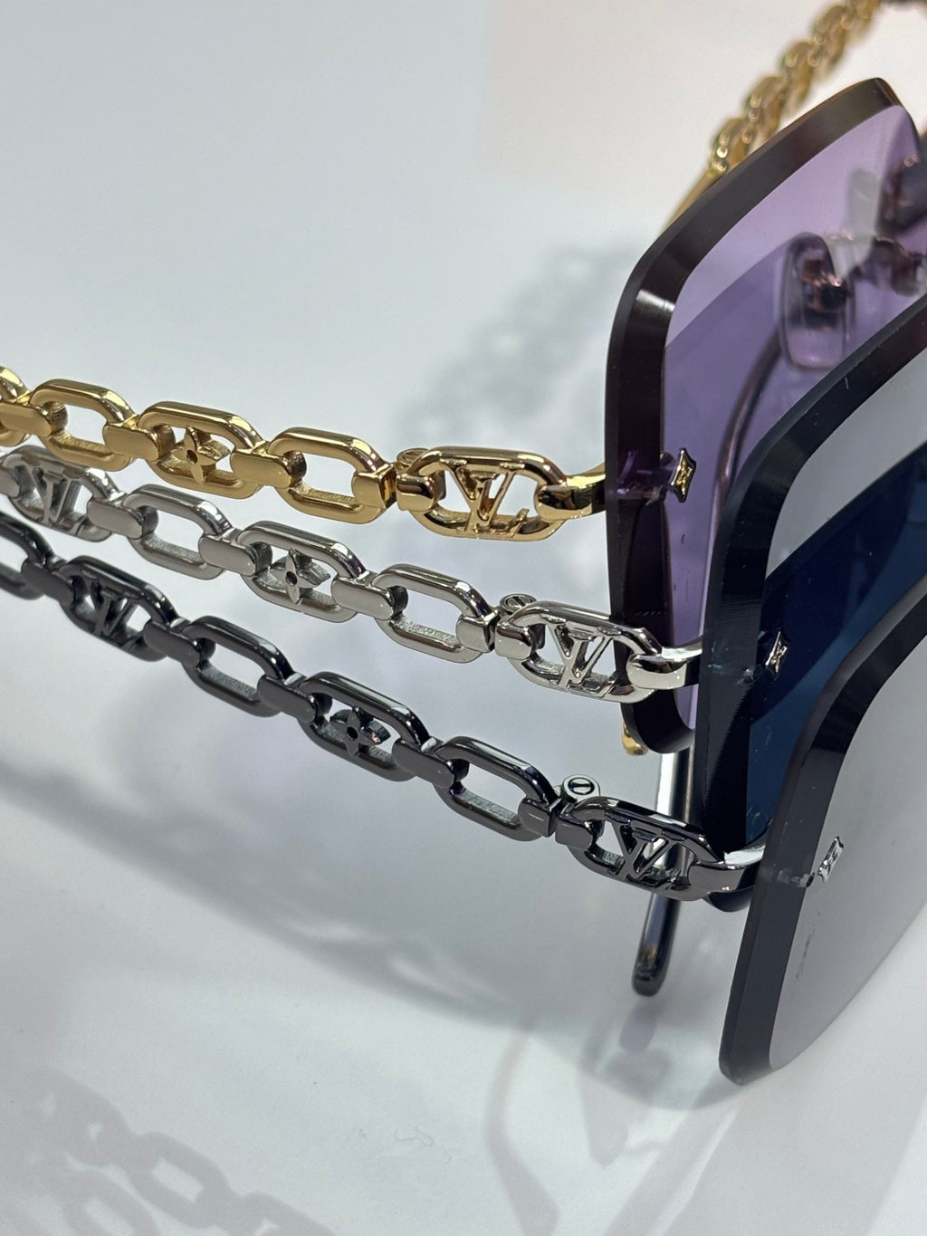 Louis Vuitton sunglasses, gold and dark chain-link temples, dark rectangular frame