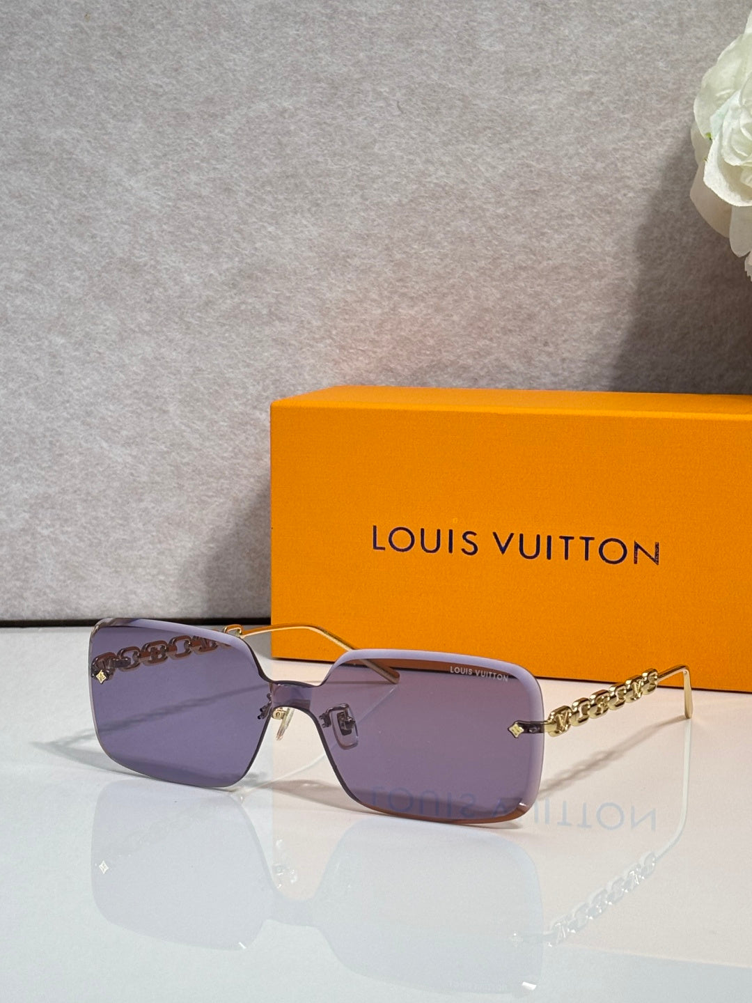 Louis Vuitton square sunglasses, purple tinted lenses, gold chain-link temples