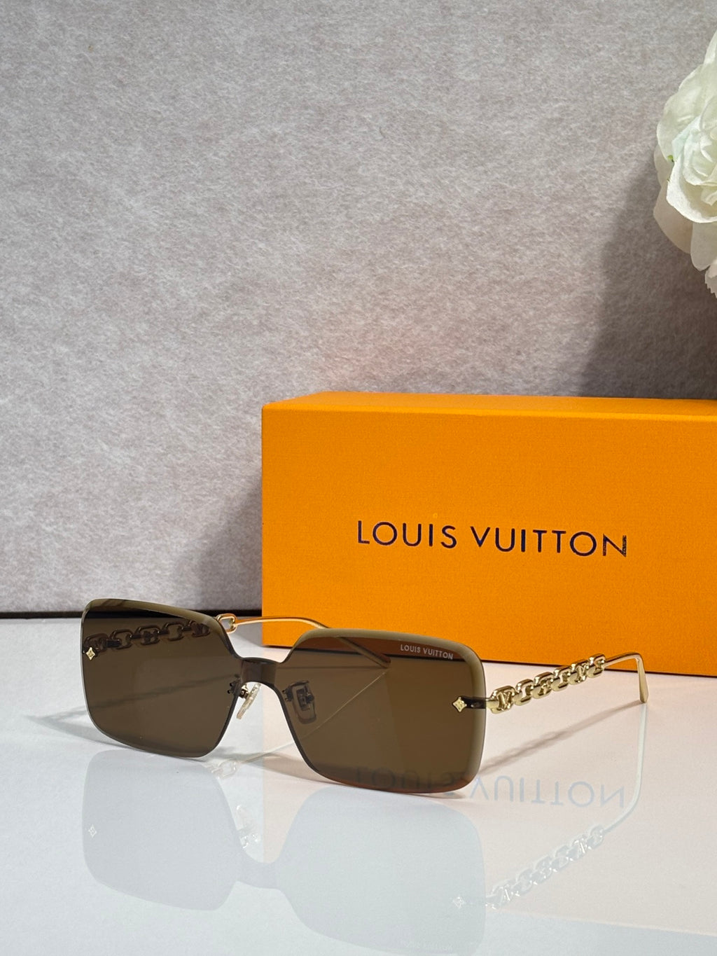 Louis Vuitton square sunglasses, light brown tinted lenses, gold chain-link temples