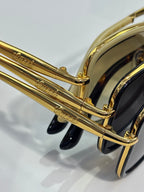 Gucci sunglasses temple detail with gold metal arms and dark acetate end pieces