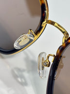 Gucci sunglasses hinge detail with gold metal and clear temple tips