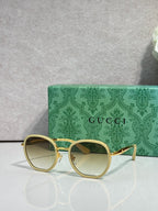 Round sunglasses with gold-tone frame, light-tinted lenses and thin temples.