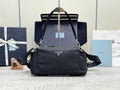Prada dark nylon handbag with top handles, shoulder strap, and front triangle logo.