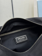 Prada dark nylon bag interior label reading PRADA with zip pocket detail.