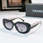 Sunglasses with dark frames and purple-tinted lenses, cat-eye style with Chanel logo