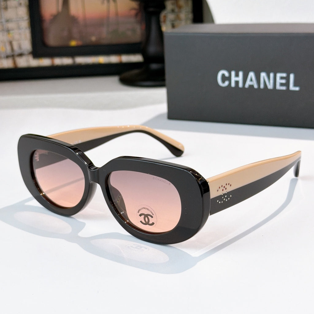 Sunglasses with black frames and pink-tinted lenses, rounded cat-eye shape with Chanel logo