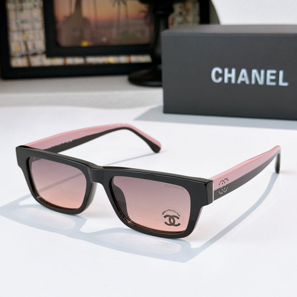 Black sunglasses with pink-tinted lenses and Chanel logo on temple